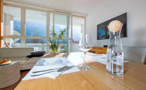 a living room with a table with a glass vase at CitySuite Lienz in Lienz