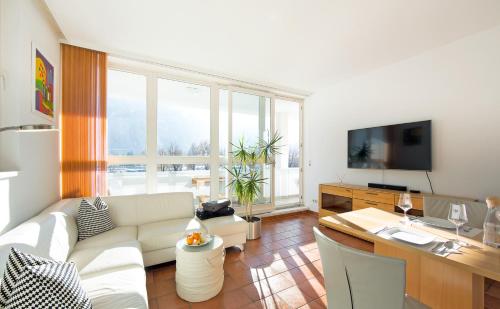 a living room with a couch and a table at CitySuite Lienz in Lienz