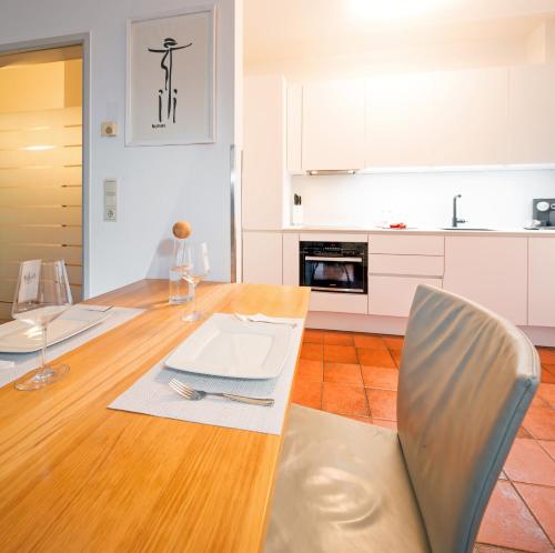a kitchen and dining room with a table and chairs at CitySuite Lienz in Lienz