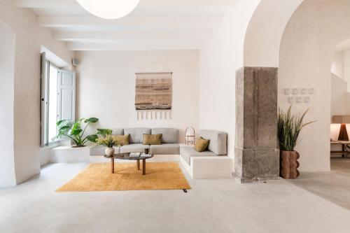 a living room with a couch and a table at Meem Townhouse in Sóller