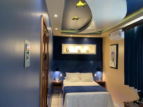 a hotel room with a bed and a mirror at Hotel Boutique TEKALI INN in Cuetzalán del Progreso