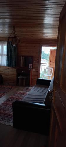 a living room with a bed and a window at Rosemary Pansiyon in Cıralı