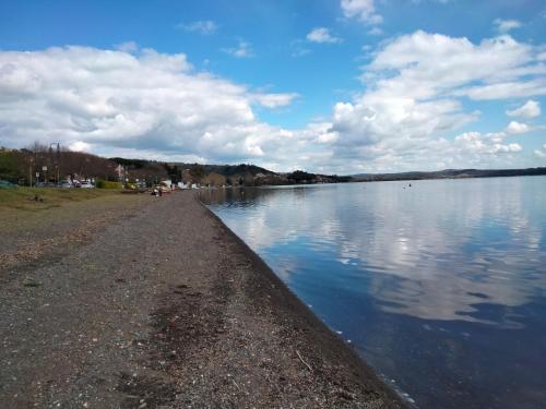 a large body of water with clouds in the sky at Sguardo sul lago in Trevignano Romano