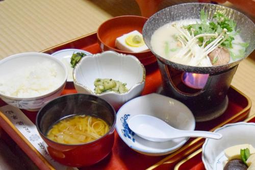 a tray of food with soup and other dishes on it at 高野山 宿坊 龍泉院 -Koyasan Shukubo Ryusenin- in Koyasan