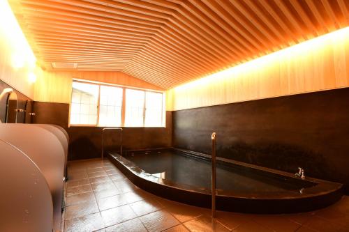 a large bath tub in a room with a table at 高野山 宿坊 龍泉院 -Koyasan Shukubo Ryusenin- in Koyasan