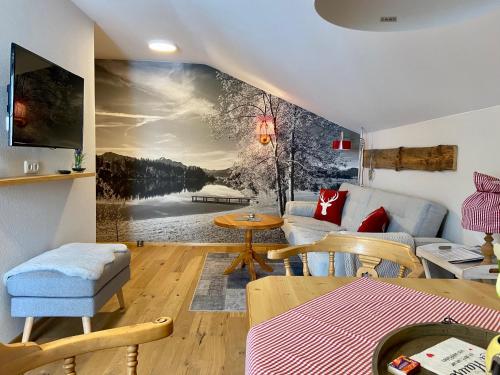 a living room with a painting of a lake at Allgäu-Moni in Füssen