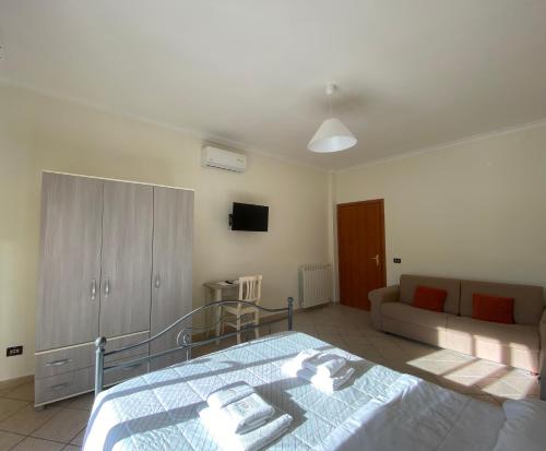 a bedroom with a bed and a couch at The Reef Apartment in Sorrento
