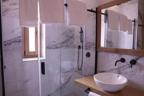 a bathroom with a shower and a white sink at Manhattan Room & Suite in Bari