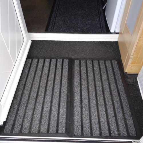 a carpeted floor in a hallway with a door at Kims Retreat in Caernarfon
