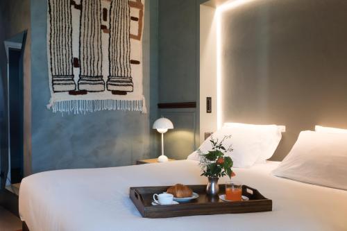 a tray of food on a bed in a room at Paradis Pietrasanta in Pietrasanta