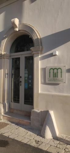 a door to a building with a sign on it at Palazzo Muro Leccese Relais de Charme & Wellness in Muro Leccese