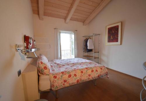 a bedroom with a bed and a window at Ferrarotti in Clavesana