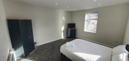 a small bedroom with a bed and a window at APARTMENT in BARNSLEY CENTRAL in Barnsley