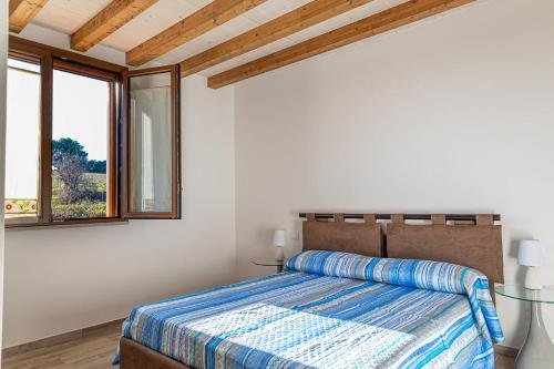 a bedroom with a bed and a window at Agriturismo San Giuseppe in Baratti