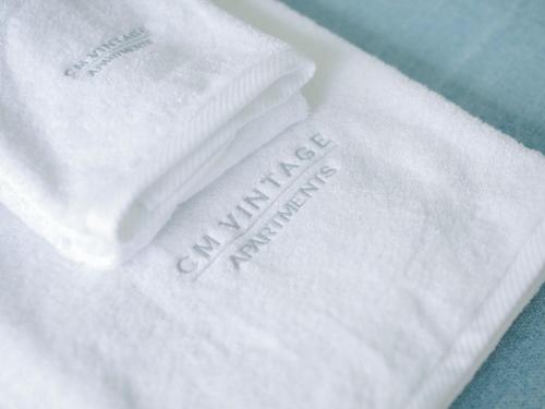 a close up of white towels with the words happy anniversary on them at CM Vintage Apartments in Porto