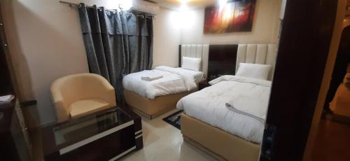 a small room with two beds and a television at Hotel Sara PVT LTD in Janakpur