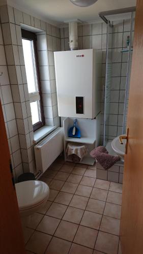 a bathroom with a toilet and a sink at Haus Ilse in Waren