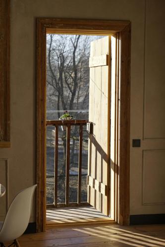 an open door to a balcony with a view at Modiste in Kuldīga