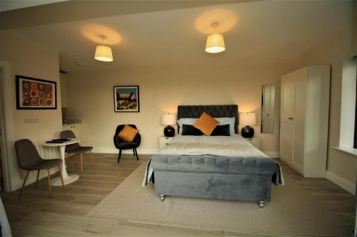 a bedroom with a bed and a table and chairs at The Shepherd's Lodge in Tullyallen