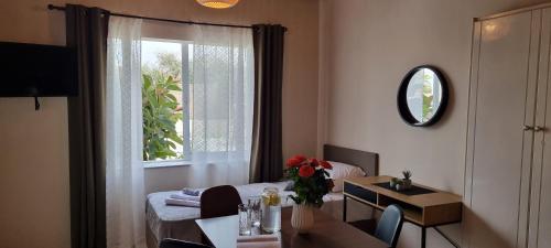 a living room with a table and a window at Secret Garden Hotel in Maleme