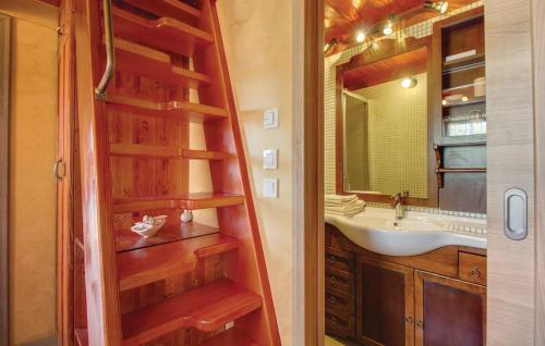 a bathroom with a wooden staircase leading to a sink at Vila s bazenom Mavrinac in Nerezine