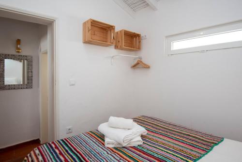 a room with a bed with two towels on it at Hillside 2 Aljezur old town in Aljezur