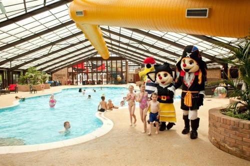 a group of people standing in front of a swimming pool at Lovely 3 bedroom 8 berth caravan in Rhyl in Rhyl