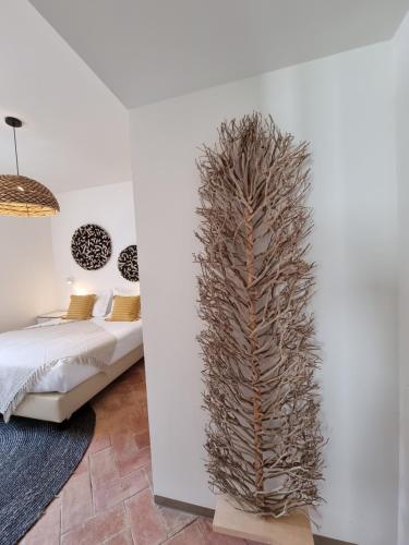 a tall plant in a room next to a bed at Casa Algarbe in Faro