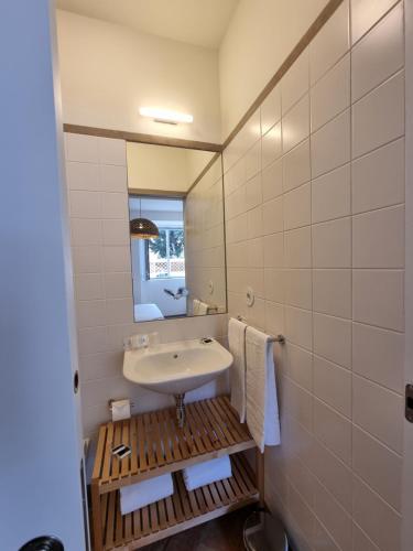 a bathroom with a sink and a mirror at Casa Algarbe in Faro