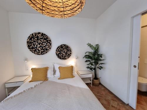 a bedroom with a large bed with yellow pillows at Casa Algarbe in Faro