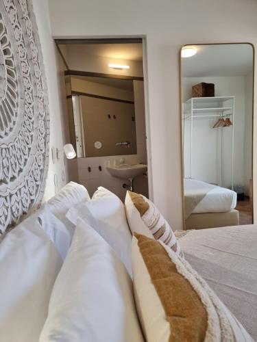 a hotel room with a bed and a mirror at Casa Algarbe in Faro