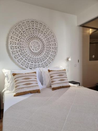 a bedroom with a large bed with two pillows at Casa Algarbe in Faro