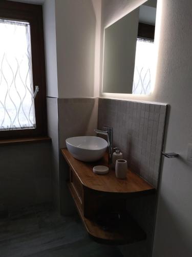 a bathroom with a sink and a mirror at Monte Zucco Relax self check in in San Pellegrino Terme