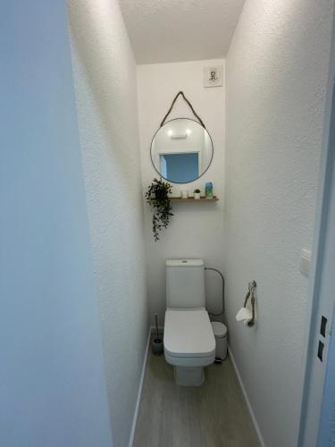 a bathroom with a white toilet and a mirror at Blue Sky La Grande Motte Studio -Pool-5min Beach -Queensizebed -WiFi in La Grande-Motte