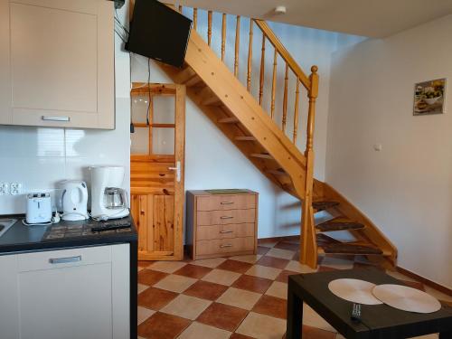 a kitchen with a spiral staircase in a house at Apartamenty Kołczewo in Kołczewo