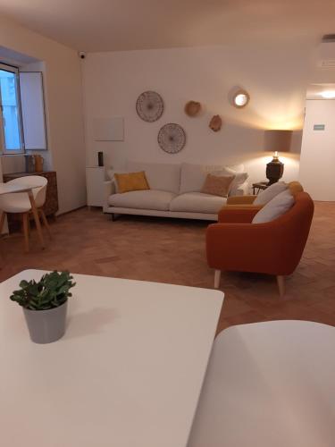 a living room with a couch and a table at Casa Algarbe in Faro