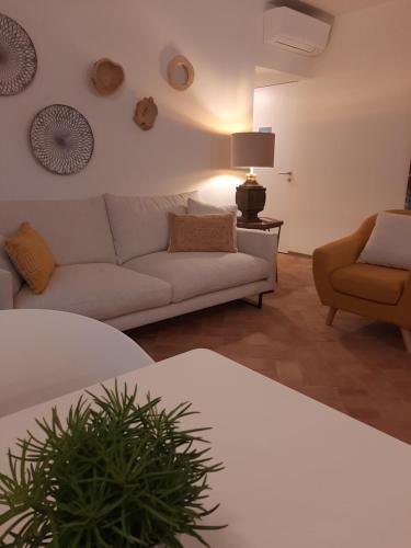 a living room with a couch and a chair at Casa Algarbe in Faro