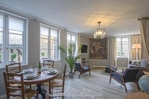 un salon avec une table, des chaises et un canapé dans l'établissement La Venelle des Greniers à Sel, à Honfleur