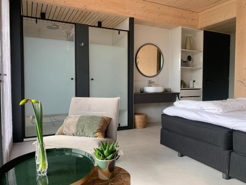 een slaapkamer met een bed en een glazen tafel bij B&B Veluwemeer in Biddinghuizen
