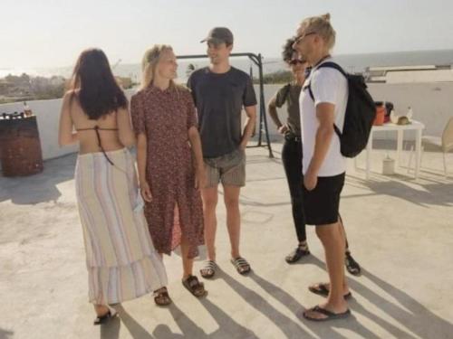 a group of people standing on a roof at Amiri in Puerto Colombia
