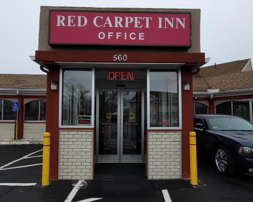 a red car parked outside of a red carpet inn office at Red Carpet Inn West Springfield in West Springfield