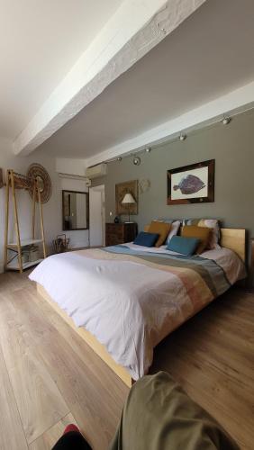 a large bedroom with a large bed in a room at Le Repaire de la Cadière à 5mn des plages ! in Saint-Cyr-sur-Mer