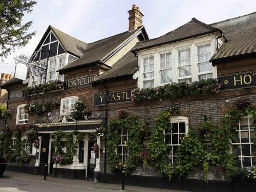 a large brick building with plants on it at The Castle Inn Hotel in Steyning