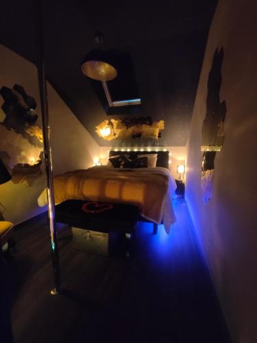 a bedroom with a bed with a blue light at La tentation in Berck-sur-Mer