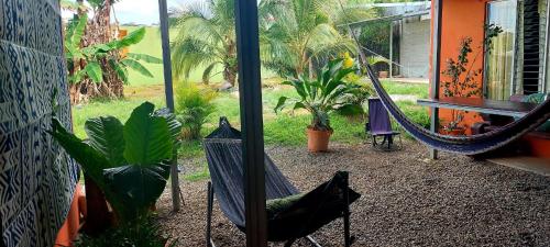 a patio with a hammock and plants in a yard at Alojamientos N&S in Fortuna