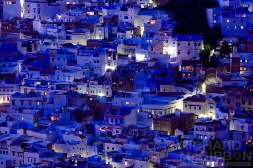 a view of a blue city at night at Lilac's Garden Cabo Negro in Cabo Negro