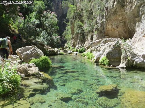 a river in a canyon with rocks and water at Lilac's Garden Cabo Negro in Cabo Negro