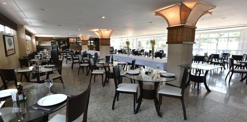 uma sala de jantar com mesas e cadeiras num restaurante em Gran Lençois Flat Residence - Barrerinhas (Aptº Particular) em Barreirinhas