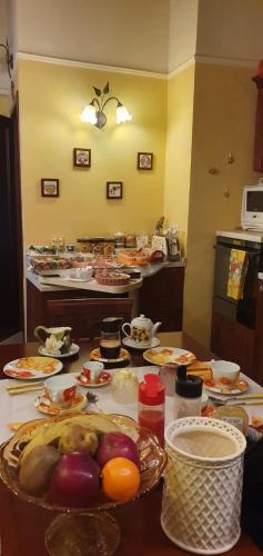a kitchen with many plates of food on a table at B&B SERENA in Perugia