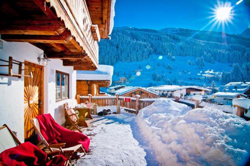 a balcony of a house with snow on the ground at Alpendorf Anno Dazumal in Tux